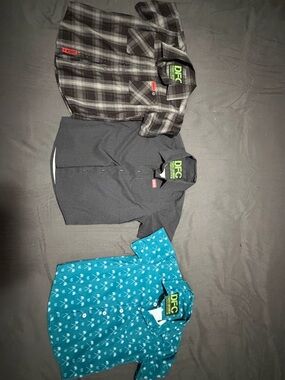 Three DIXXON youth XS Button-Up Shirts – Black Plaid, Charcoal, Teal Palm Print